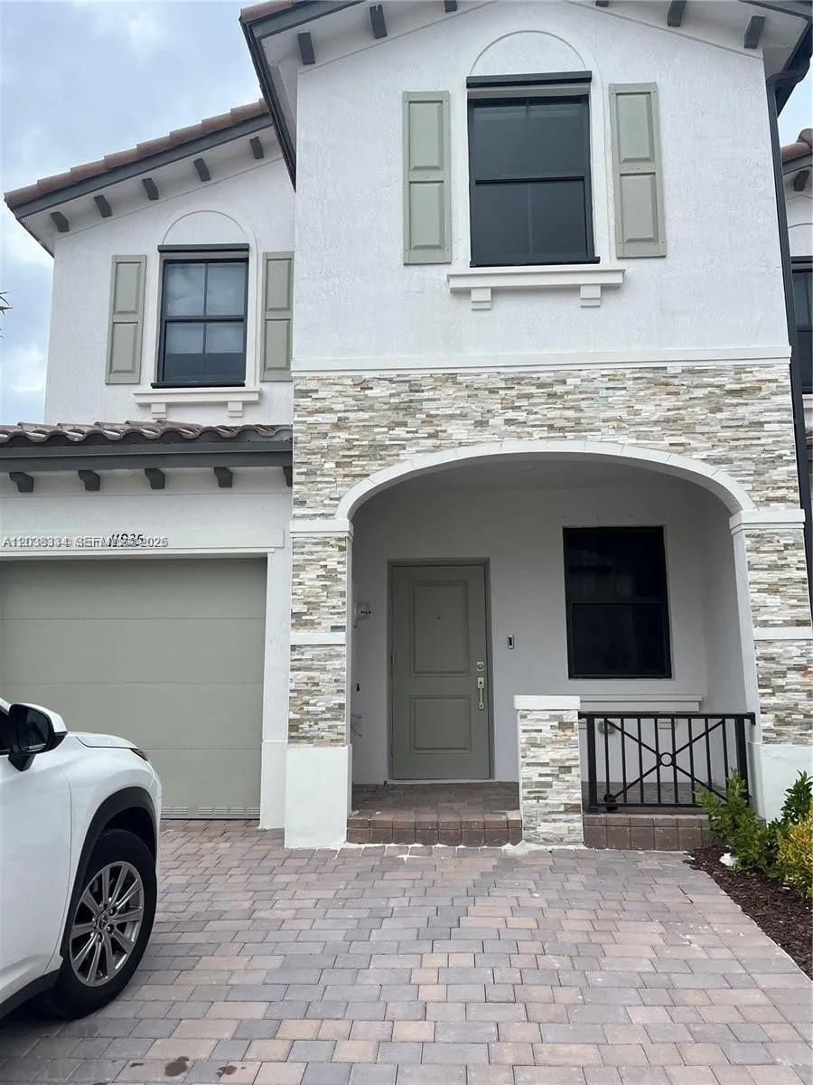 A white stucco building stands behind a stone monument sign labeled Corsica by Lennar — 11935 SW 246th Ter, Miami FL 33032, MIAMI, FL