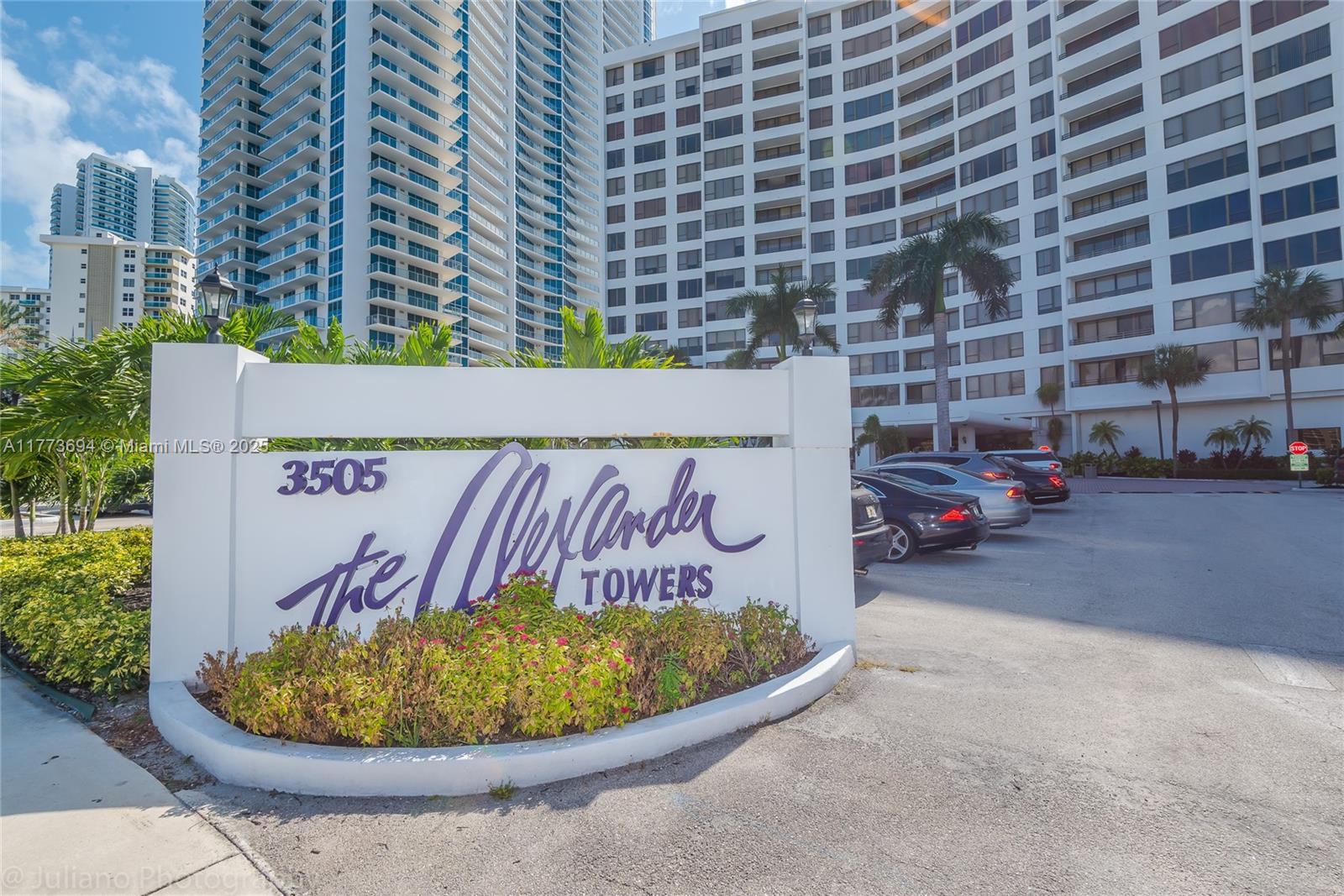 A white monument sign for The Alexander Towers stands in front of a large apartment building — 3505 S Ocean Dr # 504, Hollywood FL 33019, HOLLYWOOD, FL
