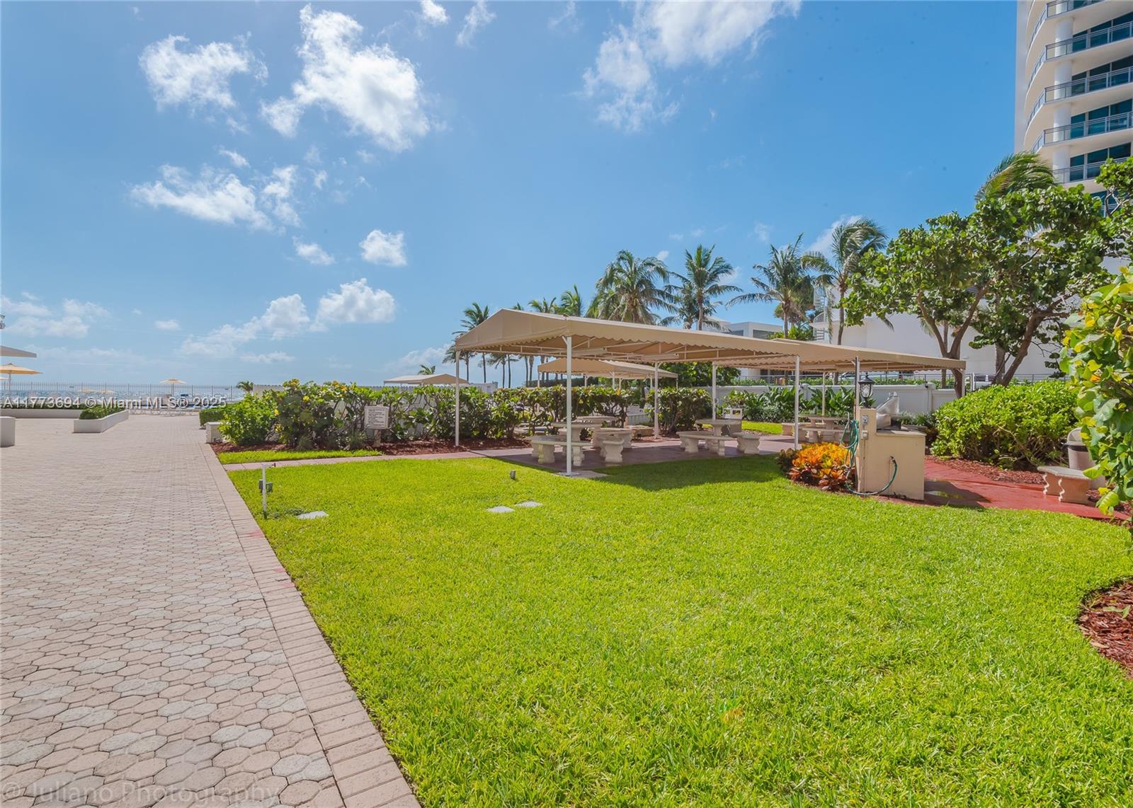 A paved walkway leads to a grassy area with a shaded picnic pavilion and palm trees — 3505 S Ocean Dr # 504, Hollywood FL 33019, HOLLYWOOD, FL