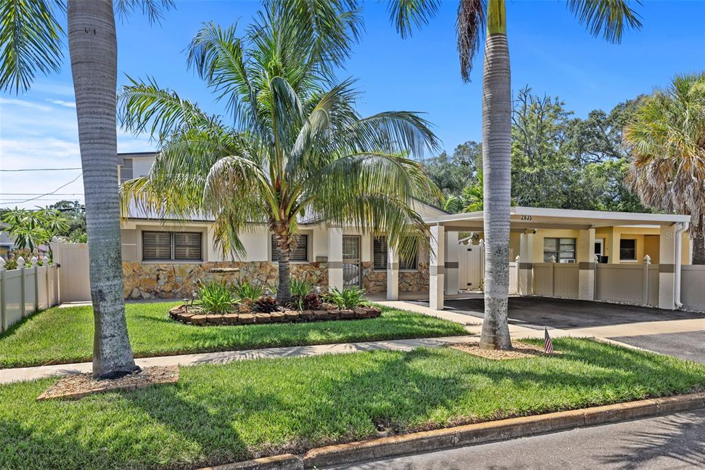 A single-story house with a stone facade, a palm tree, and a covered carport — 2035 28TH STREET S, ST PETERSBURG, FL