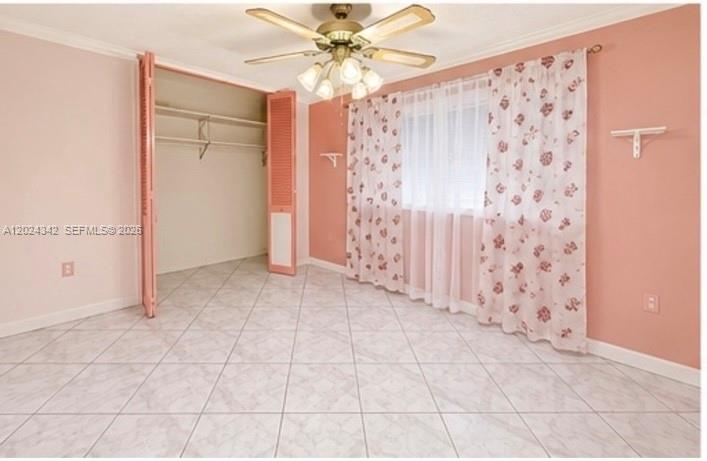 A bedroom with light pink walls, tiled floors, a ceiling fan, and a closet — 6225 SW 59th St, South Miami FL 33143, SOUTH MIAMI, FL