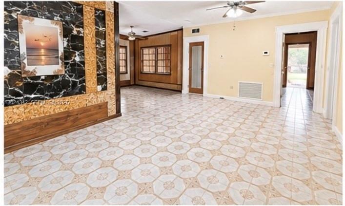 A room with patterned tile flooring, a marble-accented wall, and a doorway leading outside — 6225 SW 59th St, South Miami FL 33143, SOUTH MIAMI, FL