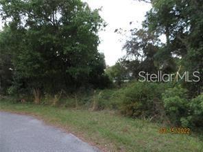A view of a wooded, undeveloped residential lot from a paved road — GAGSTATTER ROAD, NORTH PORT, FL