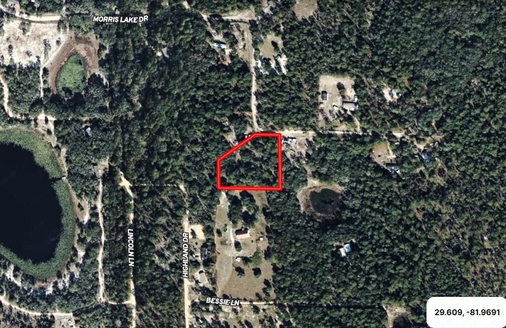 An aerial map view shows a wooded lot outlined in red near local roads — 121 Susan Road, FL 32640, FL