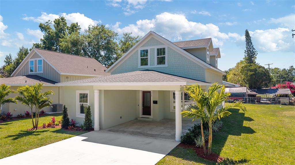 An exterior view of a light green two-story house with a covered front porch — 25 EDWARDS STREET, PLANT CITY, FL