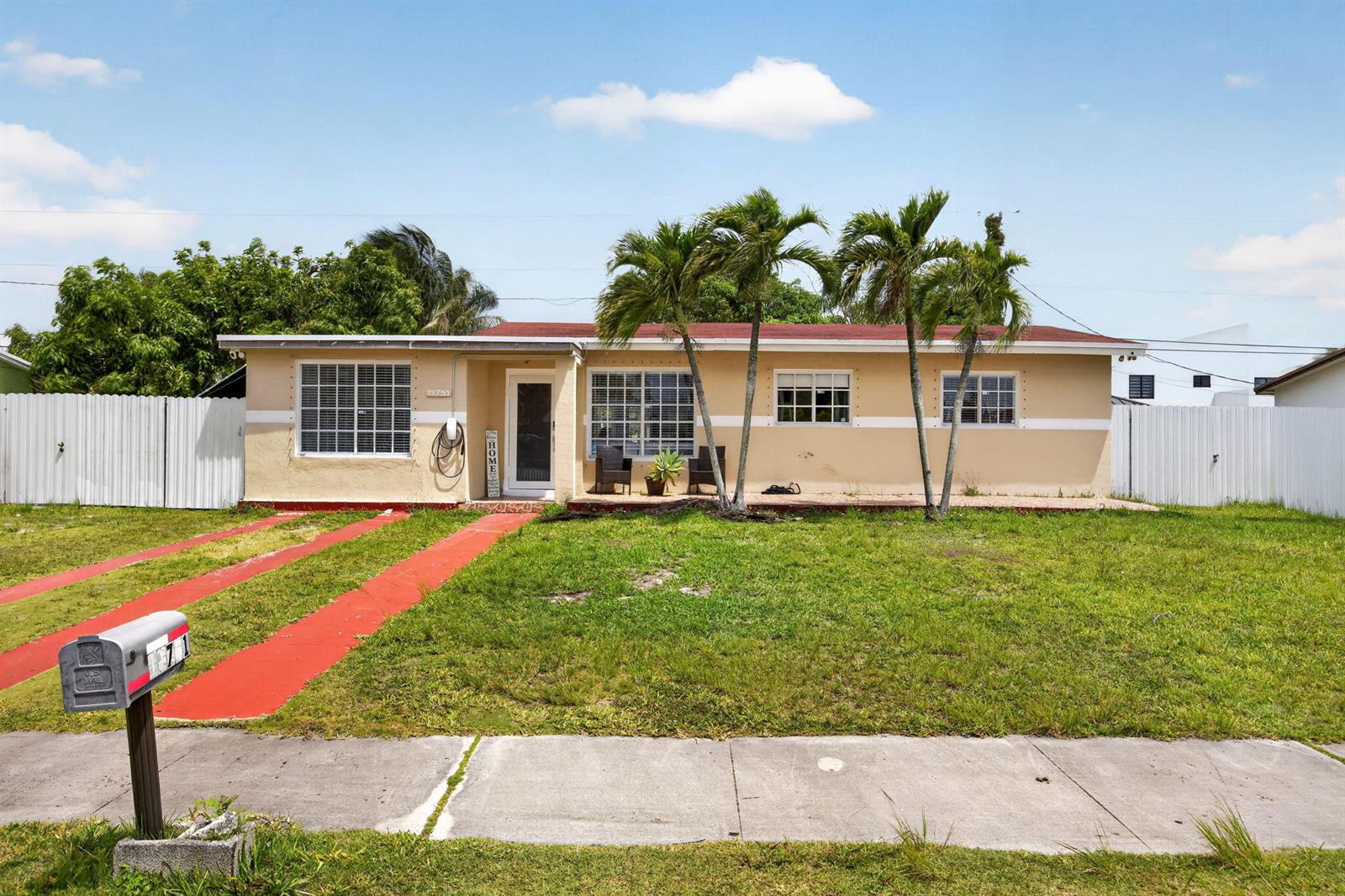 A single-story house with a tan exterior, red roof, and three palm trees in front — 11751 SW 185th Terrace, Miami FL 33177, MIAMI, FL