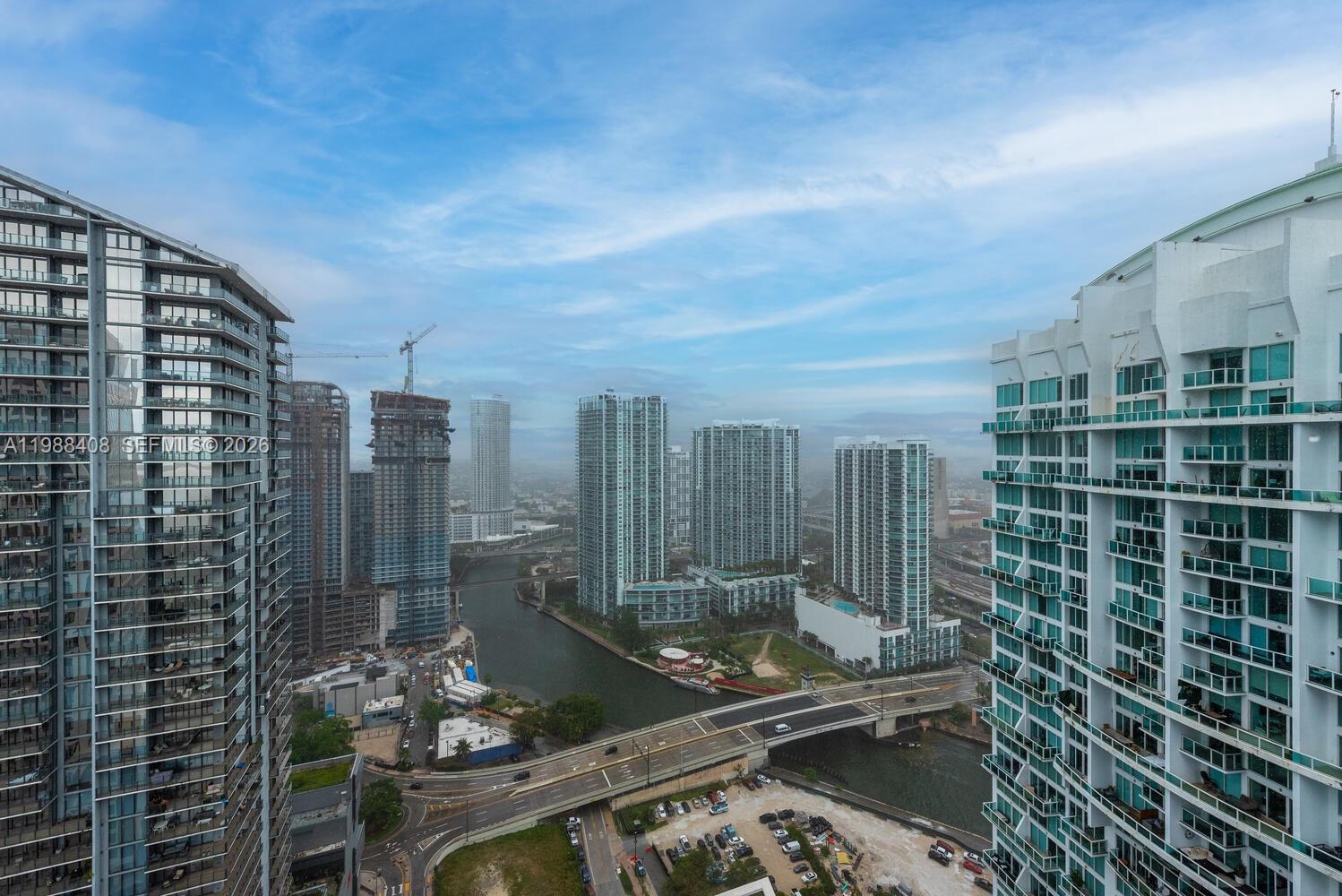 An elevated view of a city skyline featuring high-rise buildings, a river, and a bridge — 55 SE 6th St # 4200, Miami FL 33131, MIAMI, FL