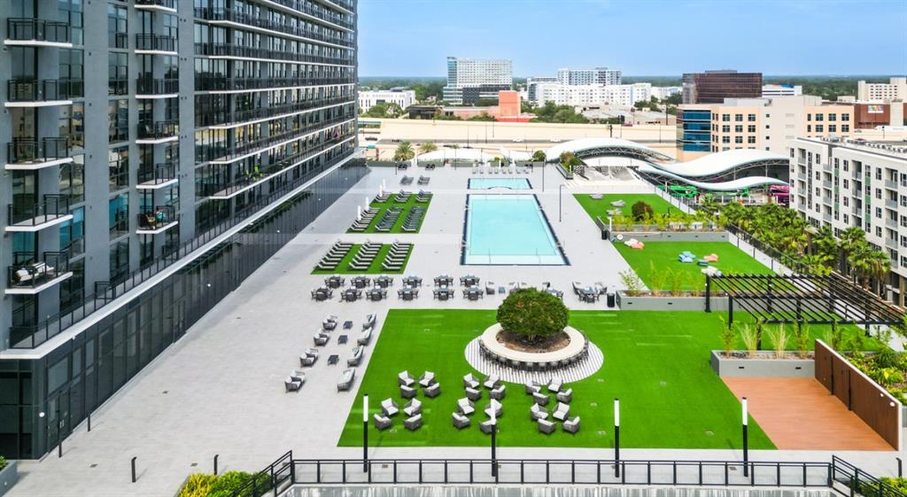 An elevated view of an apartment complex terrace featuring a swimming pool and green space — 434 N ORANGE AVENUE, ORLANDO, FL