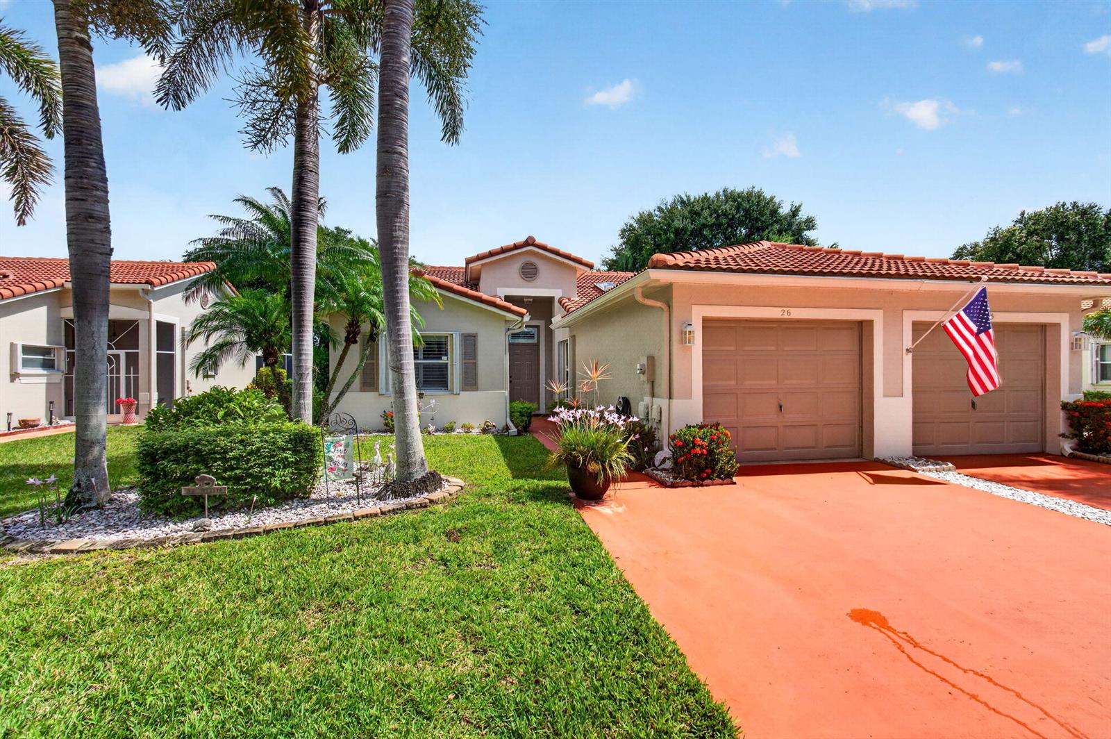 A single-story house with a red tile roof, two garage doors, and a landscaped yard — 26 Sausalito Drive, Boynton Beach FL 33436, BOYNTON BEACH, FL