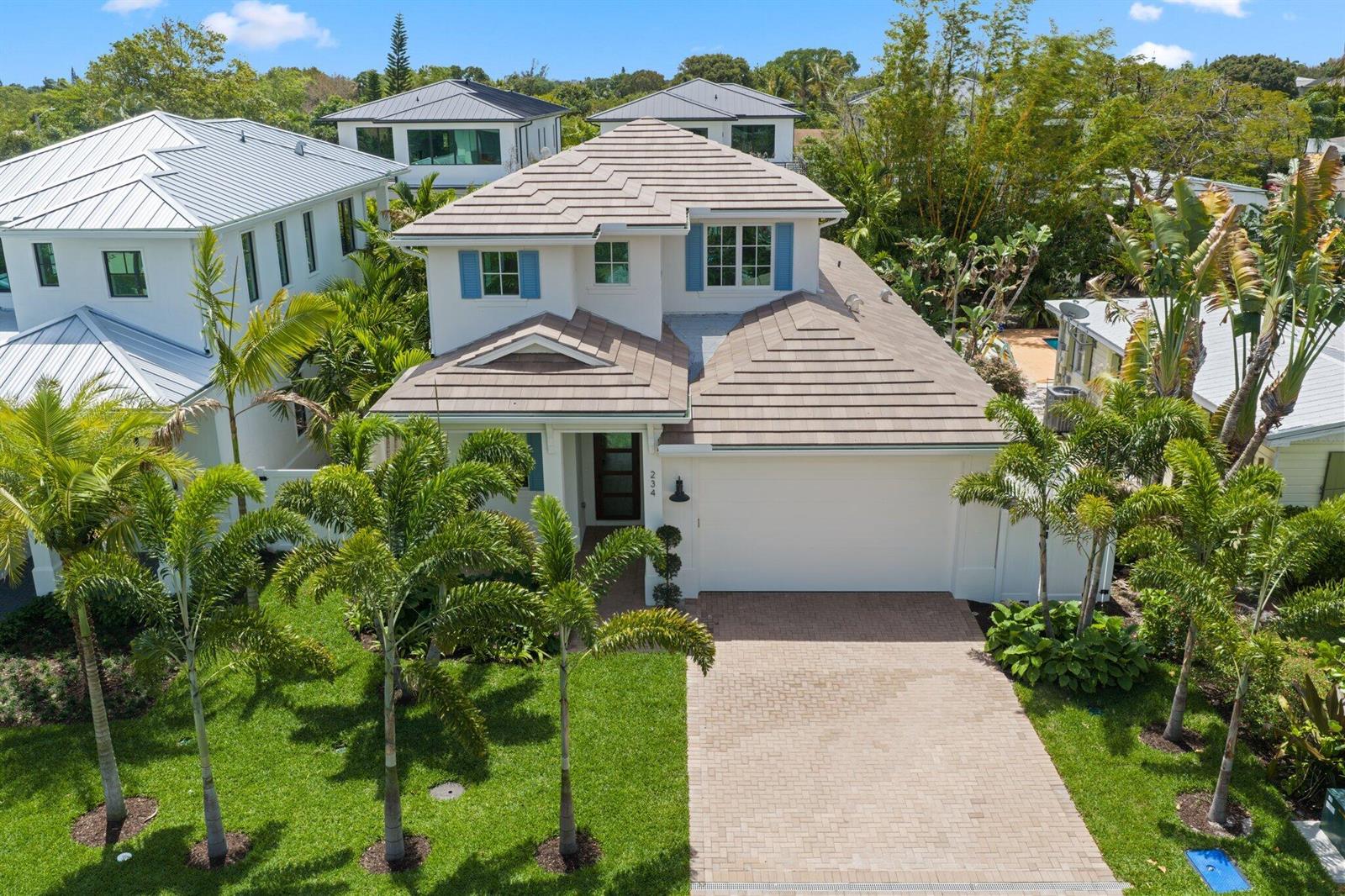 An aerial view shows a two-story house with a tiled roof, white siding, and palm trees — 234 NE 12th Street, Delray Beach FL 33444, DELRAY BEACH, FL