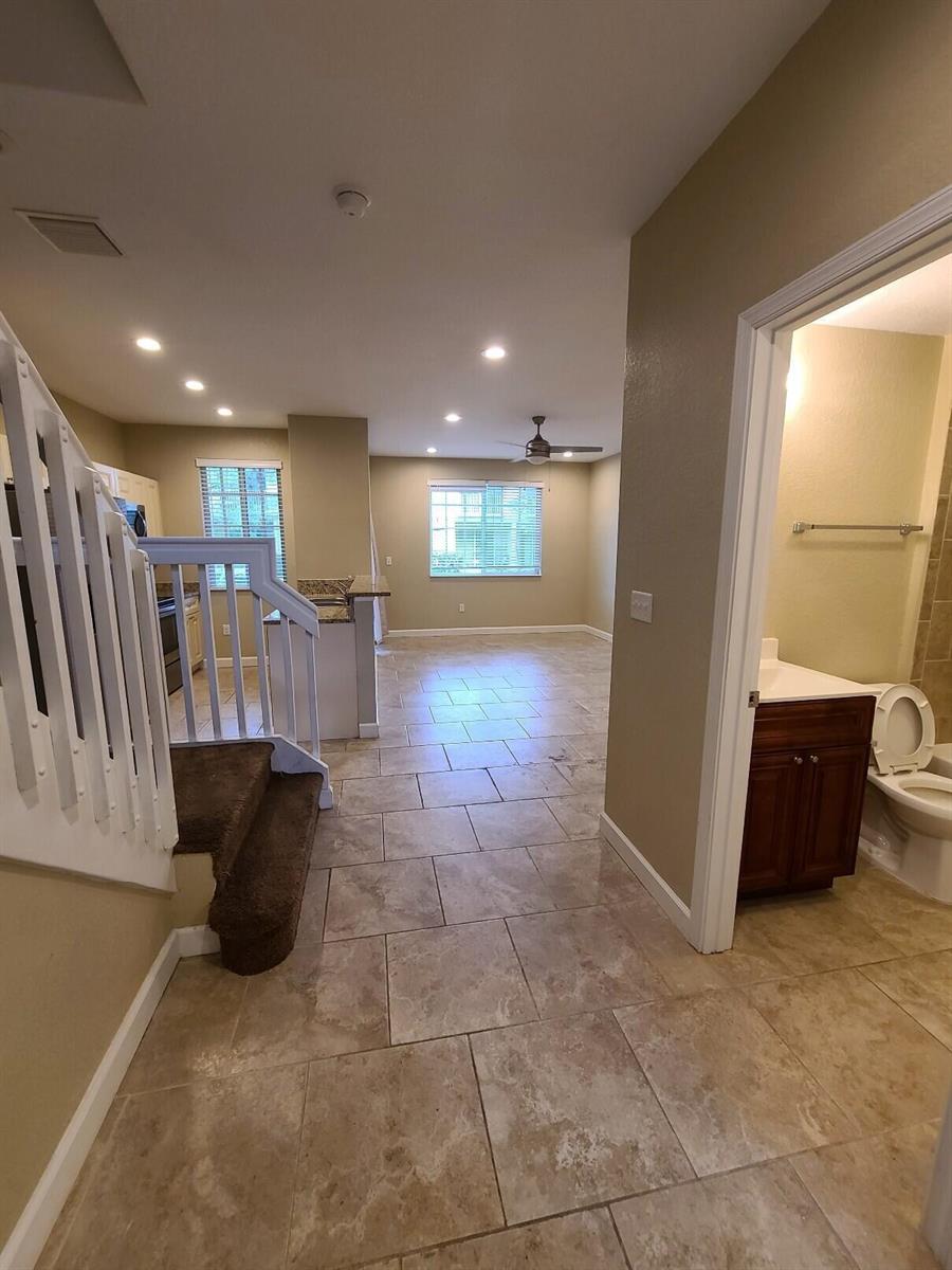 A view from a hallway looking toward a kitchen and living area with tiled floors — 1952 Flamingo Place, West Palm Beach FL 33404, WEST PALM BEACH, FL