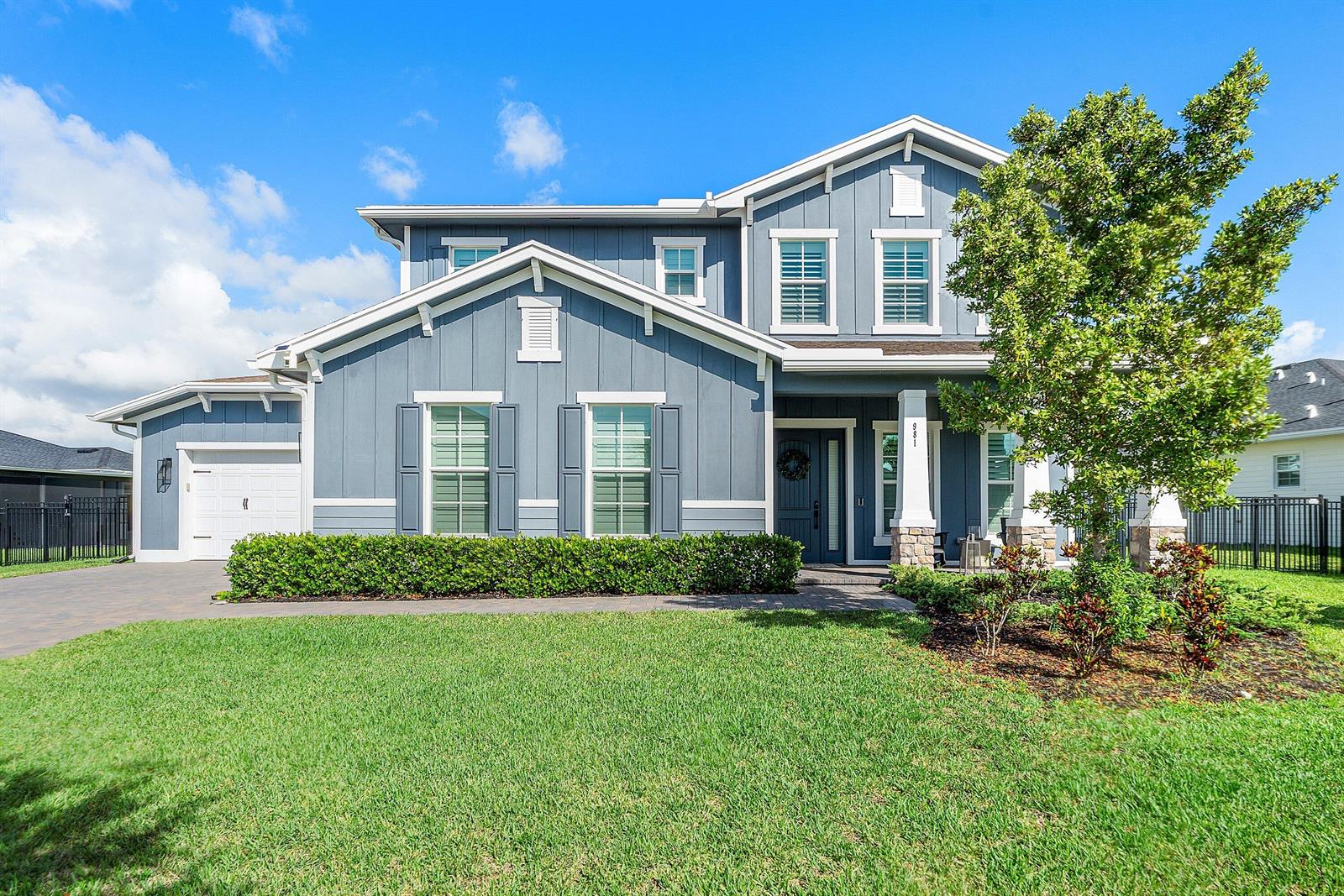A two-story blue house with a brick paver driveway and a front lawn — 981 Castaway Court, Loxahatchee FL 33470, LOXAHATCHEE, FL