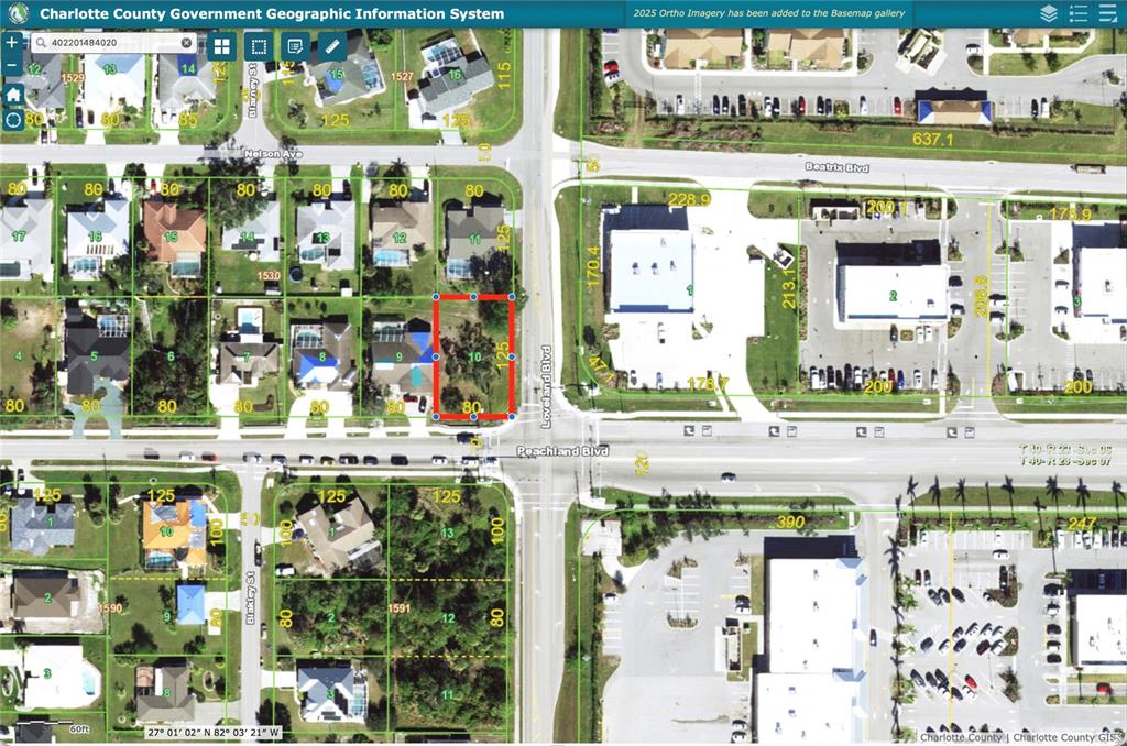 This is a GIS map showing a residential lot highlighted in red near a commercial intersection — 23540 PEACHLAND BOULEVARD, PORT CHARLOTTE, FL