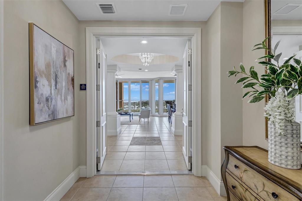 A tiled entryway leads through double doors into a bright living area with ocean views — 130 RIVIERA DUNES WAY UNIT 804, PALMETTO, FL