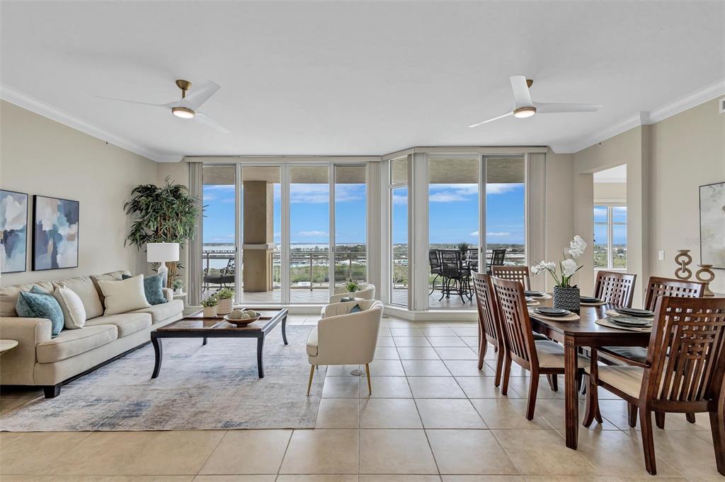 A living and dining area features tile floors, large windows, and a view of water — 130 RIVIERA DUNES WAY UNIT 804, PALMETTO, FL