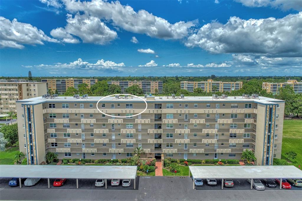 An aerial view of a multi-story apartment building with a circled top-floor unit — 3820 IRONWOOD LANE UNIT 603I, BRADENTON, FL