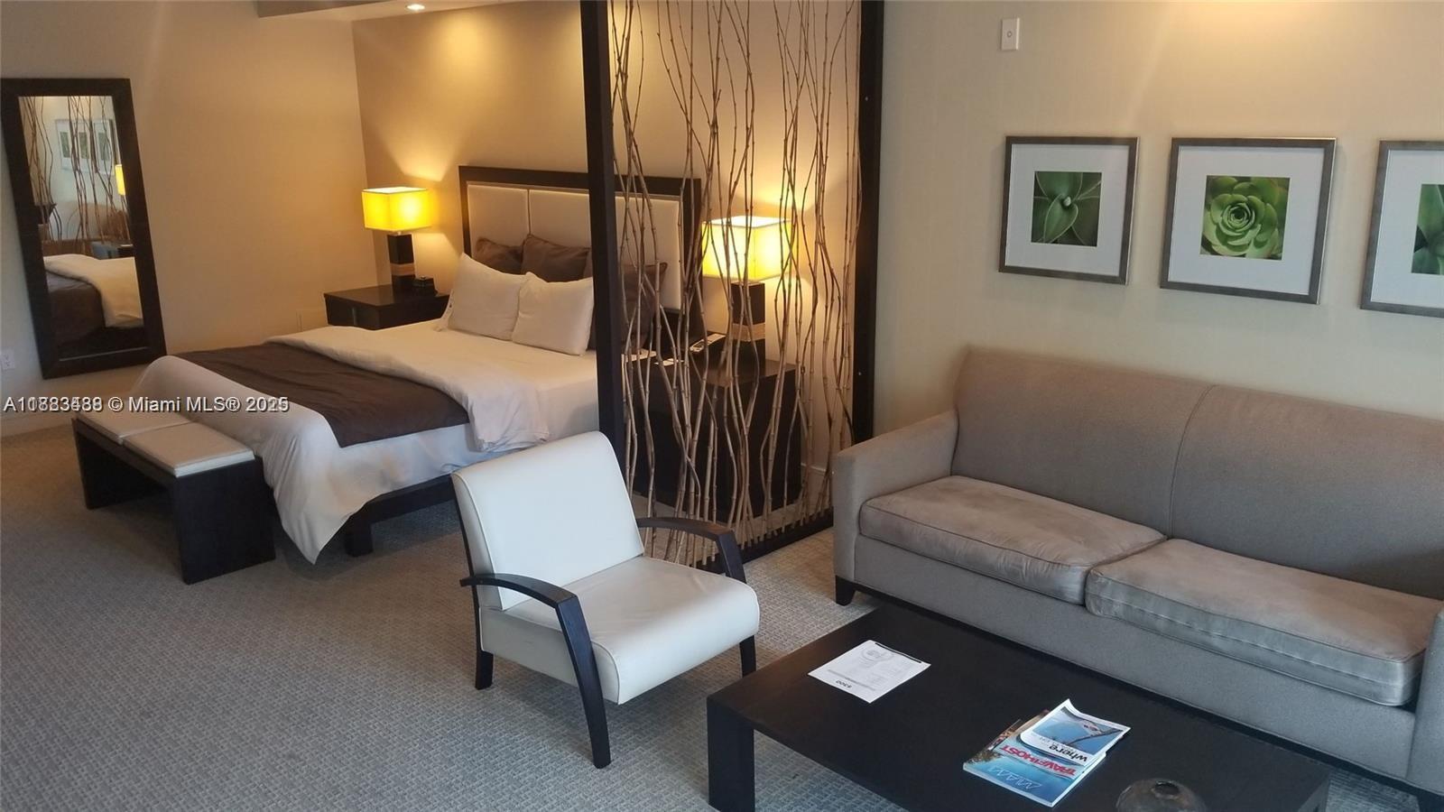 A hotel-style room features a bed, a sofa, a coffee table, and a decorative partition — 5300 NW 87th Ave # 415, Doral FL 33178, DORAL, FL