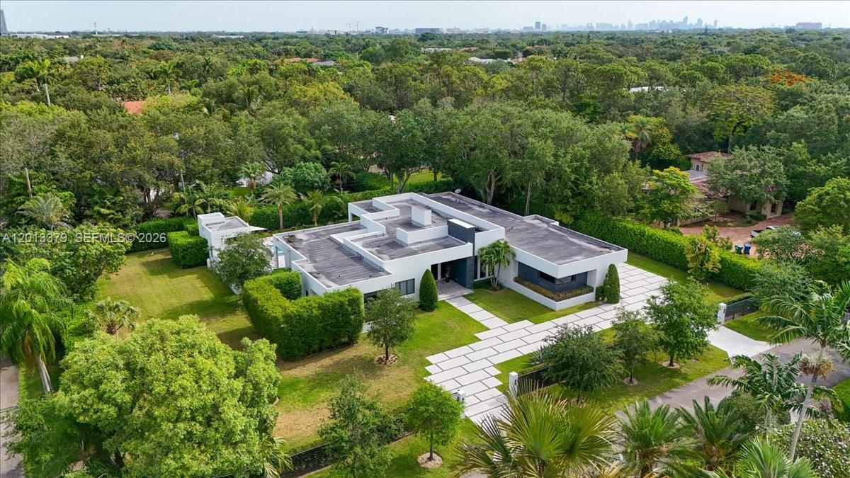 An aerial view of a modern flat-roofed house surrounded by lush trees and landscaping — 6785 SW 99th Ter, Pinecrest FL 33156, PINECREST, FL