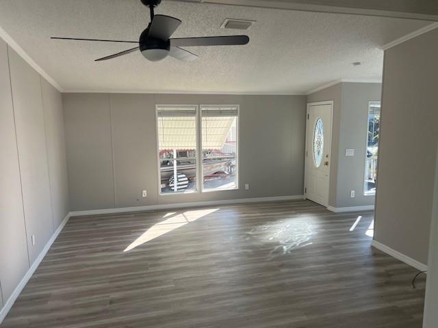 An empty living room features light gray walls, wood-look flooring, a ceiling fan, and windows — 1601 Hwy 441, Okeechobee FL 34974, OKEECHOBEE, FL