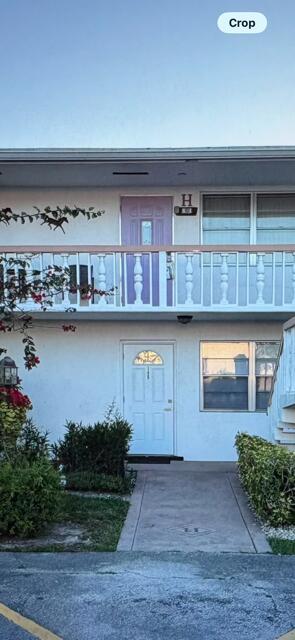 A two-story building exterior features a white ground-floor door and a purple upper-level door — 145 Northampton # H, West Palm Beach FL 33417, WEST PALM BEACH, FL