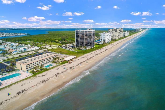 An aerial view of a beachfront property with high-rise condominiums and a swimming pool — 9800 S Ocean 107 Drive # 107, Jensen Beach FL 34957, JENSEN BEACH, FL