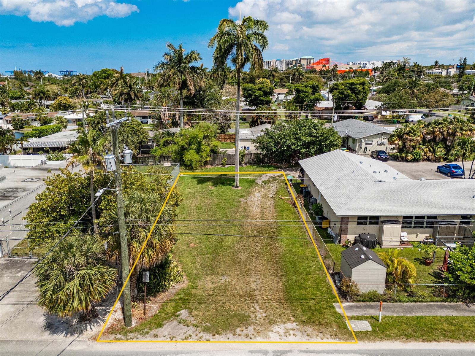 An aerial view shows a vacant, rectangular grass lot situated between two residential properties — 0 NE 1st Avenue, Dania Beach FL 33004, DANIA BEACH, FL