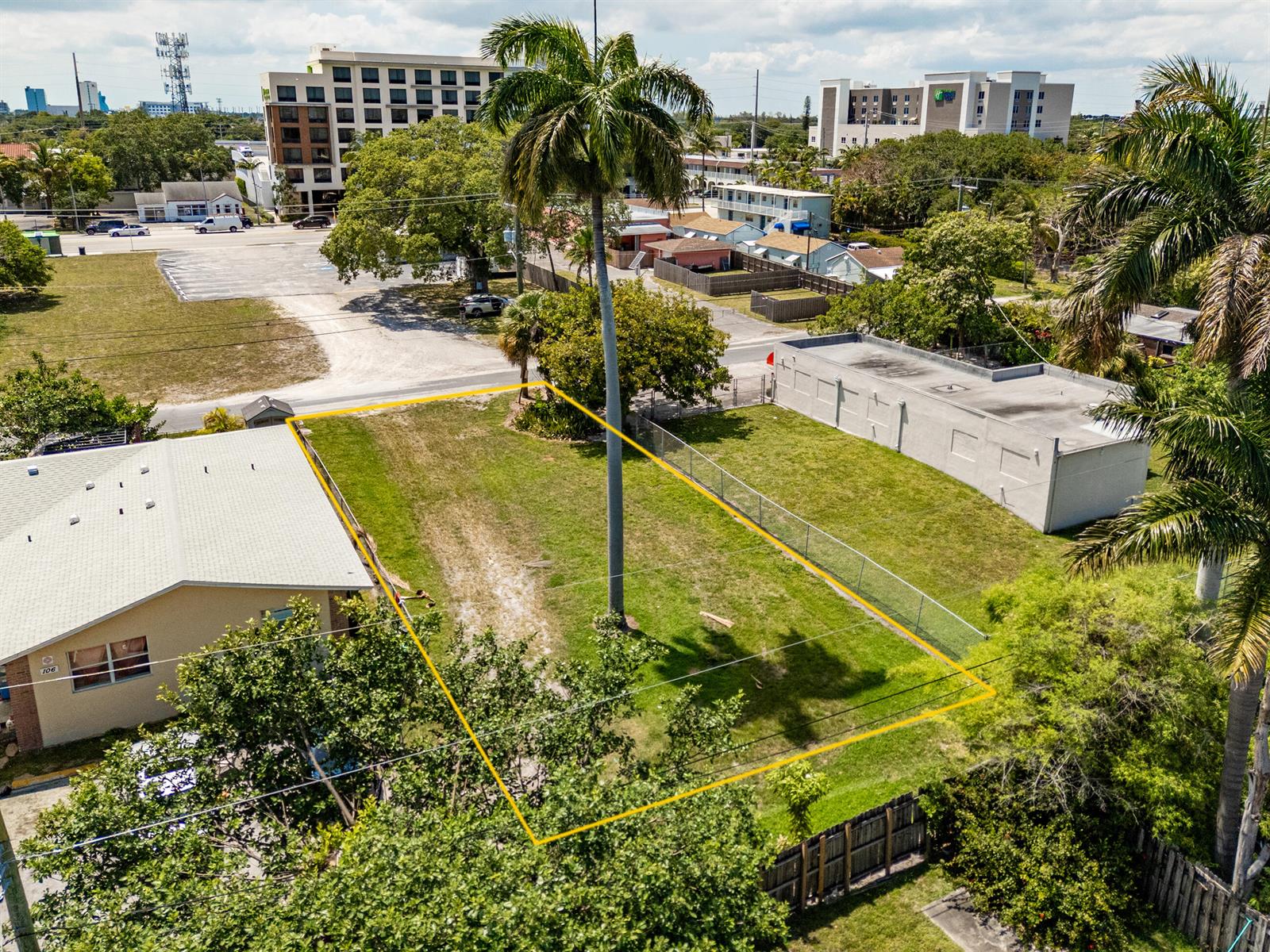 An aerial view shows a rectangular vacant lot outlined in yellow next to a building — 0 NE 1st Avenue, Dania Beach FL 33004, DANIA BEACH, FL