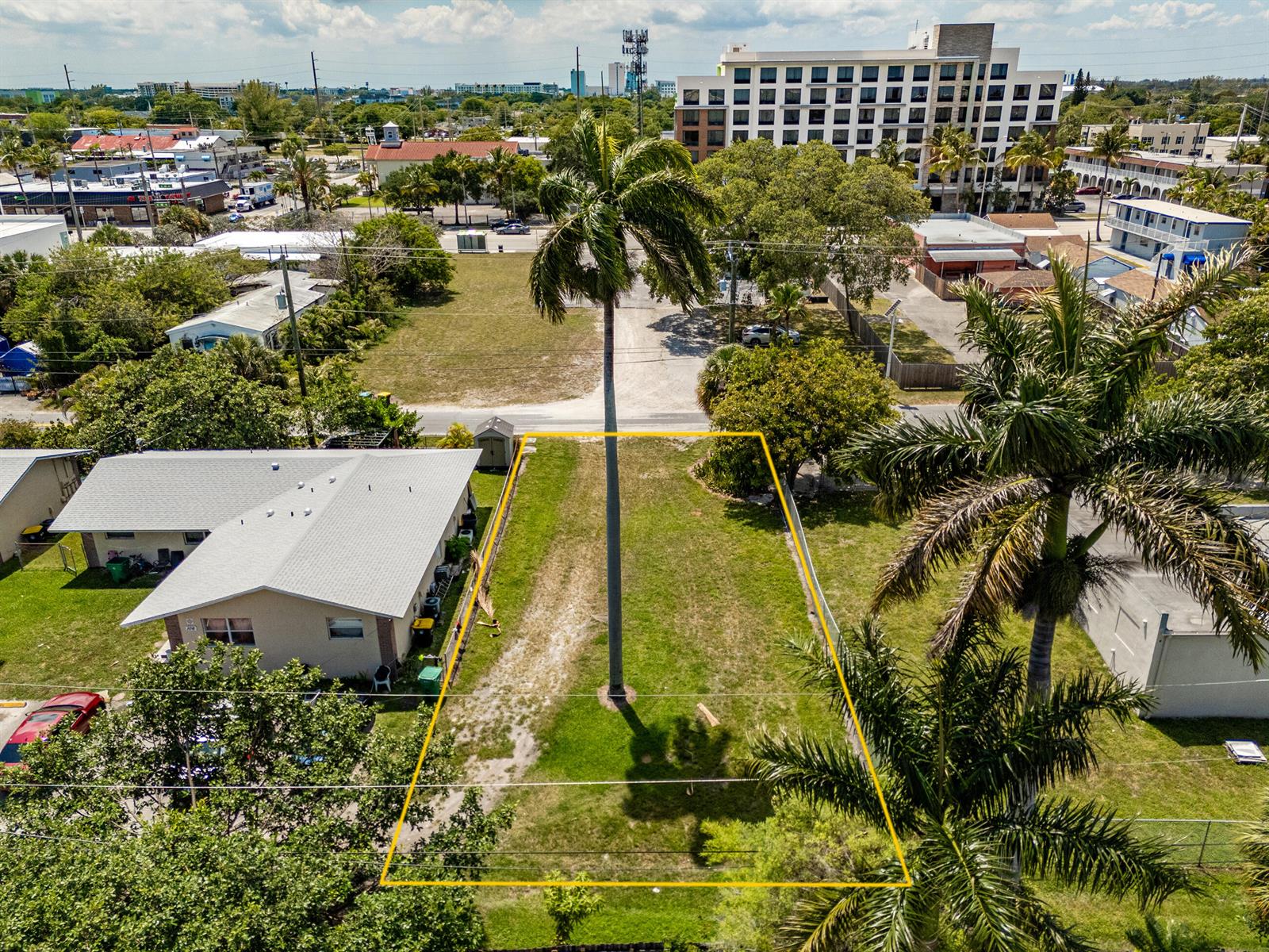 An aerial view shows a vacant rectangular lot outlined in yellow next to a house — 0 NE 1st Avenue, Dania Beach FL 33004, DANIA BEACH, FL