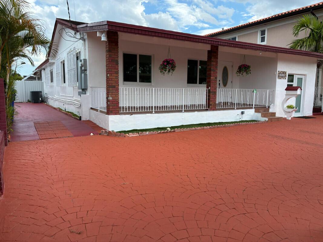 A single-story house with a white exterior, brick pillars, and a red stamped concrete driveway — 2828 SW 2nd Street, Miami FL 33135, MIAMI, FL