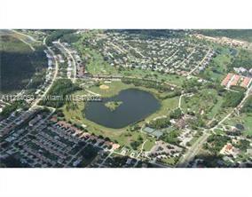 An aerial view shows a residential neighborhood surrounding a large lake and a golf course — 4420 FETTUCCINE AVE, Sebring FL 33872, SEBRING, FL