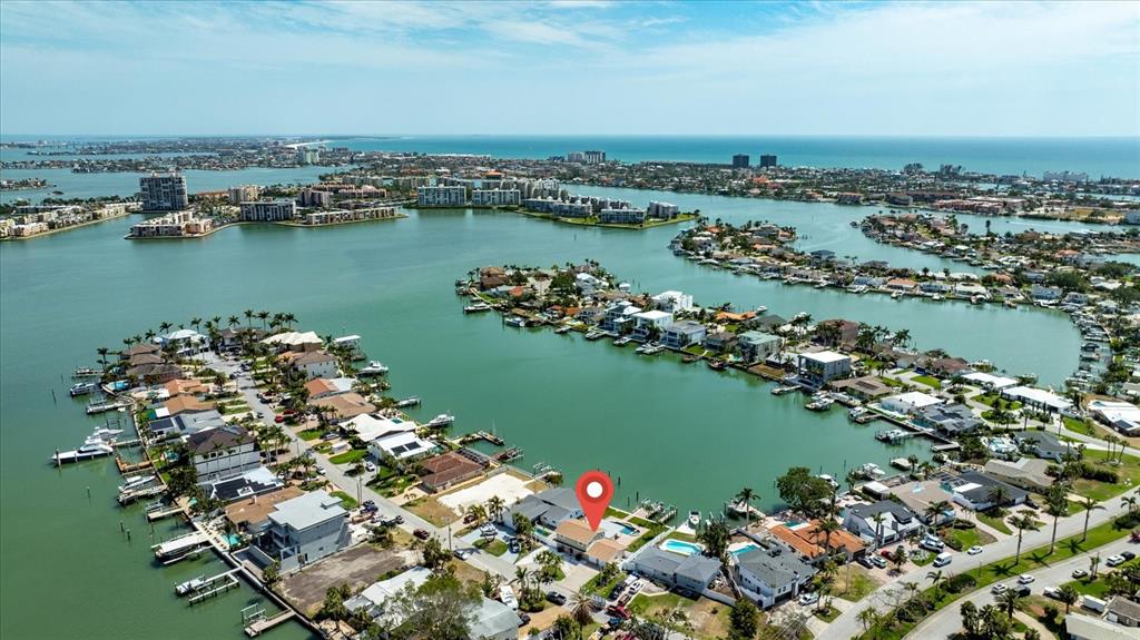 An aerial view shows a waterfront house with a red location pin on a canal — 7886 9TH AVENUE S, ST PETERSBURG, FL
