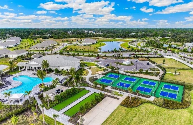 An aerial view of a community clubhouse featuring a swimming pool, tennis courts, and landscaping — 16087 IVY RIDGE COURT, PORT CHARLOTTE, FL