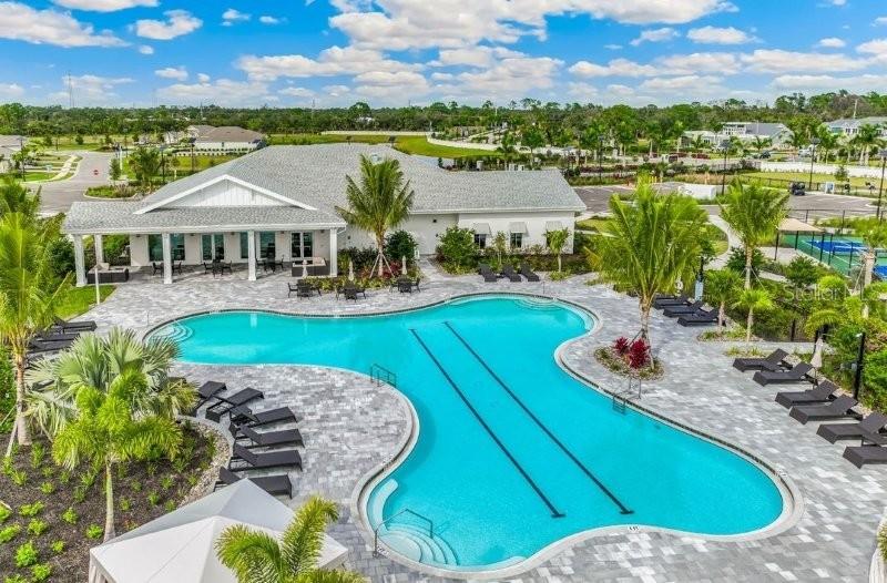 An aerial view shows a community swimming pool with lap lanes next to a clubhouse — 16087 IVY RIDGE COURT, PORT CHARLOTTE, FL
