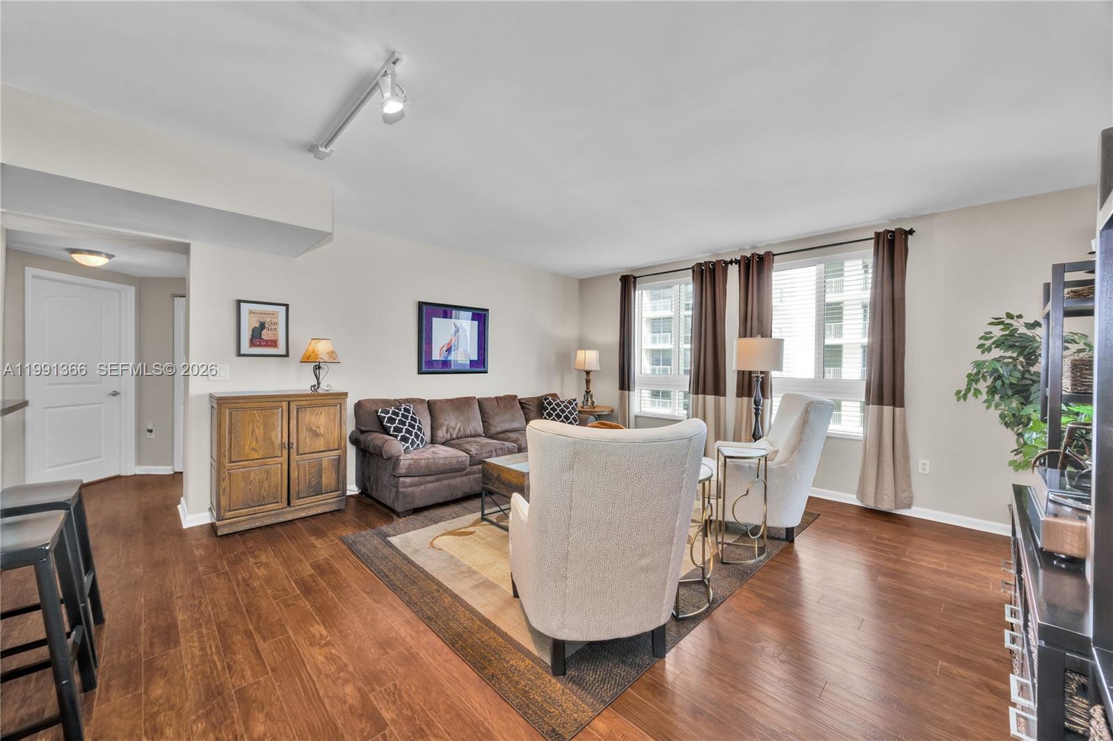 A living room features a brown sofa, two armchairs, and wood flooring — 7350 SW 89th St # 1511S, Miami FL 33156, MIAMI, FL