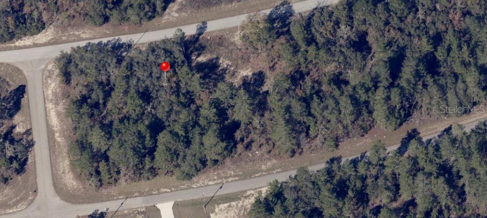 An aerial view shows a wooded, undeveloped plot of land bordered by two paved roads — Lot 2 SW 153RD STREET, OCALA, FL