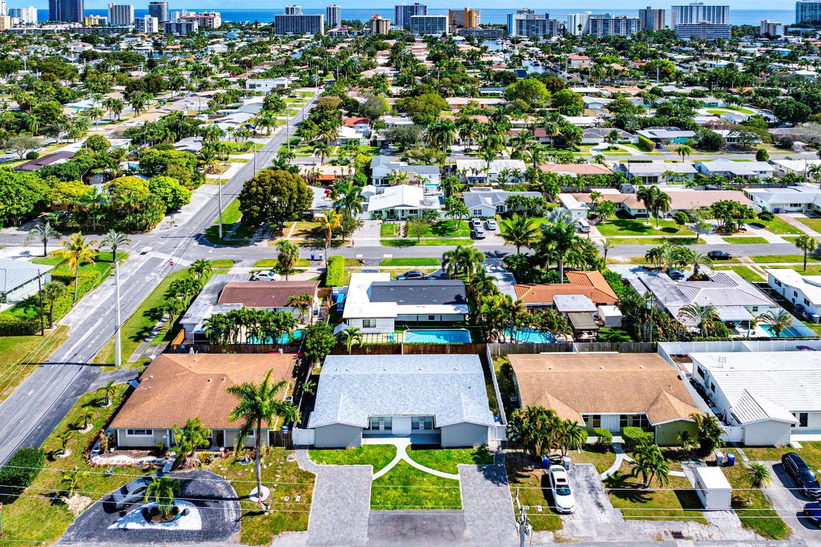 An aerial view of a residential neighborhood featuring single-story homes with pools and palm trees — 708-710 NE 23rd Avenue, Pompano Beach FL 33062, POMPANO BEACH, FL