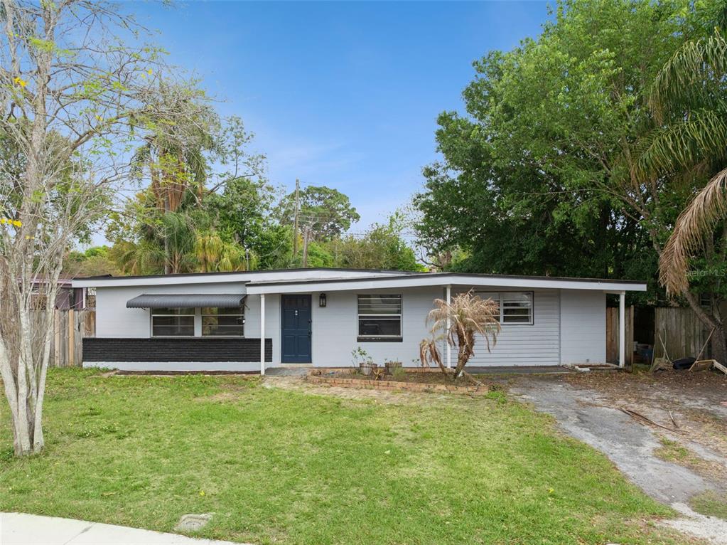 A single-story house with a gray exterior, a dark blue front door, and a driveway — 617 BEVERLY AVENUE, ALTAMONTE SPRINGS, FL