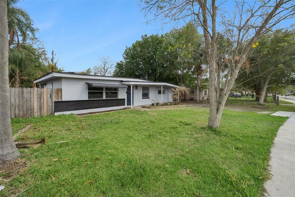 A single-story house with gray and black exterior walls sits on a grassy lot — 617 BEVERLY AVENUE, ALTAMONTE SPRINGS, FL