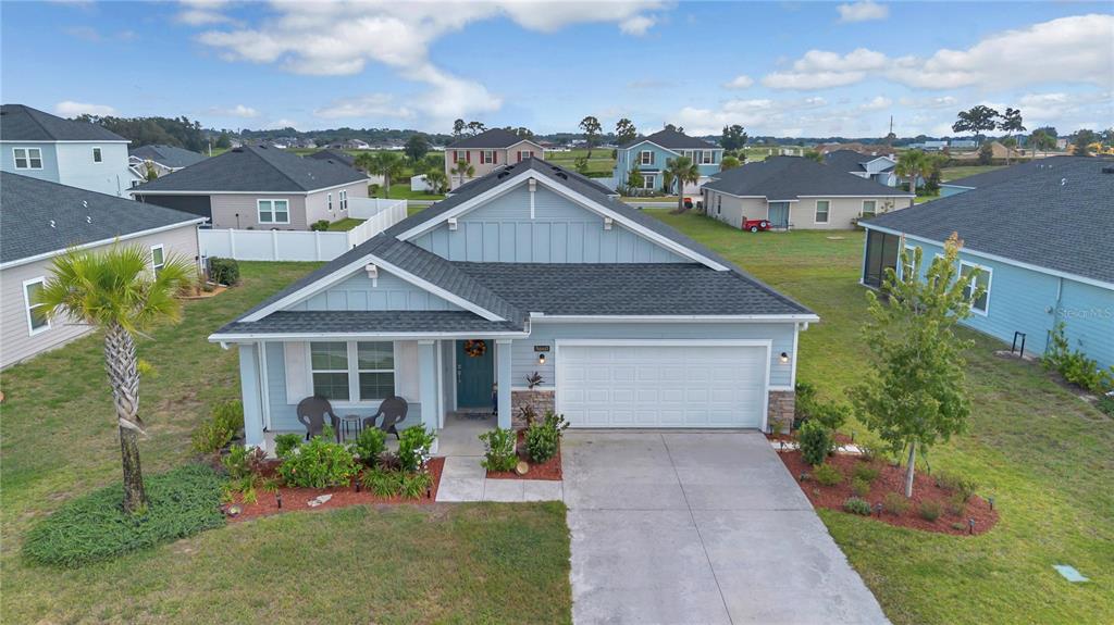 A light blue single-story house with a two-car garage and a front porch — 5660 SW 93RD STREET, OCALA, FL