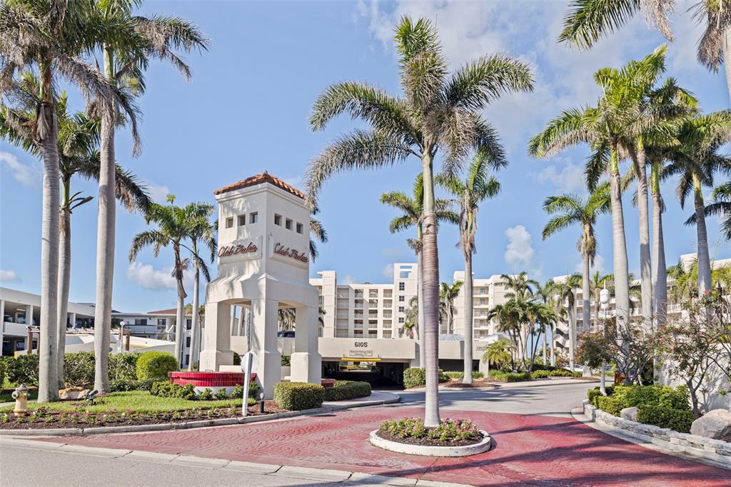 The exterior view shows a tall entrance monument with palm trees and a multi-story building — 6105 BAHIA DEL MAR CIRCLE UNIT 683, ST PETERSBURG, FL