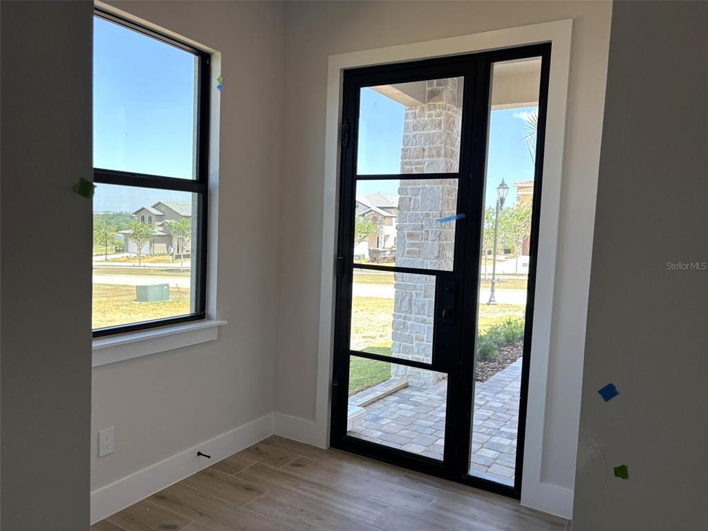 A two-story suburban house with a paver driveway, two-car garage, and a side yard — 16308 VETTA DRIVE, MONTVERDE, FL