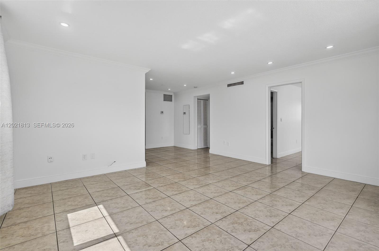 An empty room features white walls, recessed lighting, and light-colored square floor tiles — 1020 94th St # 301, Bay Harbor Islands FL 33154, BAY HARBOR ISLANDS, FL