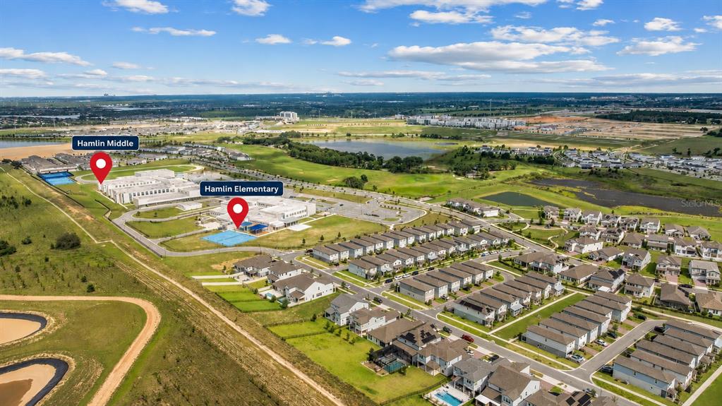 An aerial view shows Hamlin Elementary and Middle schools surrounded by suburban housing developments — 16055 SILVER BROOK WAY, WINTER GARDEN, FL