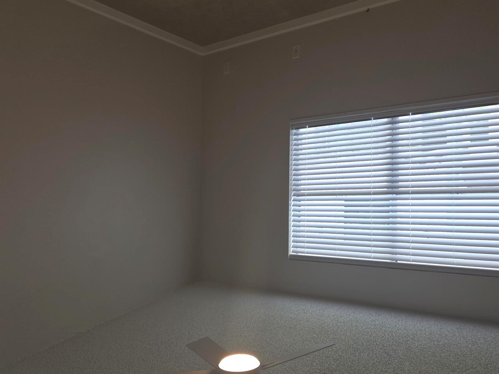 An empty room with beige walls, light-colored carpet, a ceiling fan, and a window with blinds — 2843 NE 15th Street, Pompano Beach FL 33062, POMPANO BEACH, FL