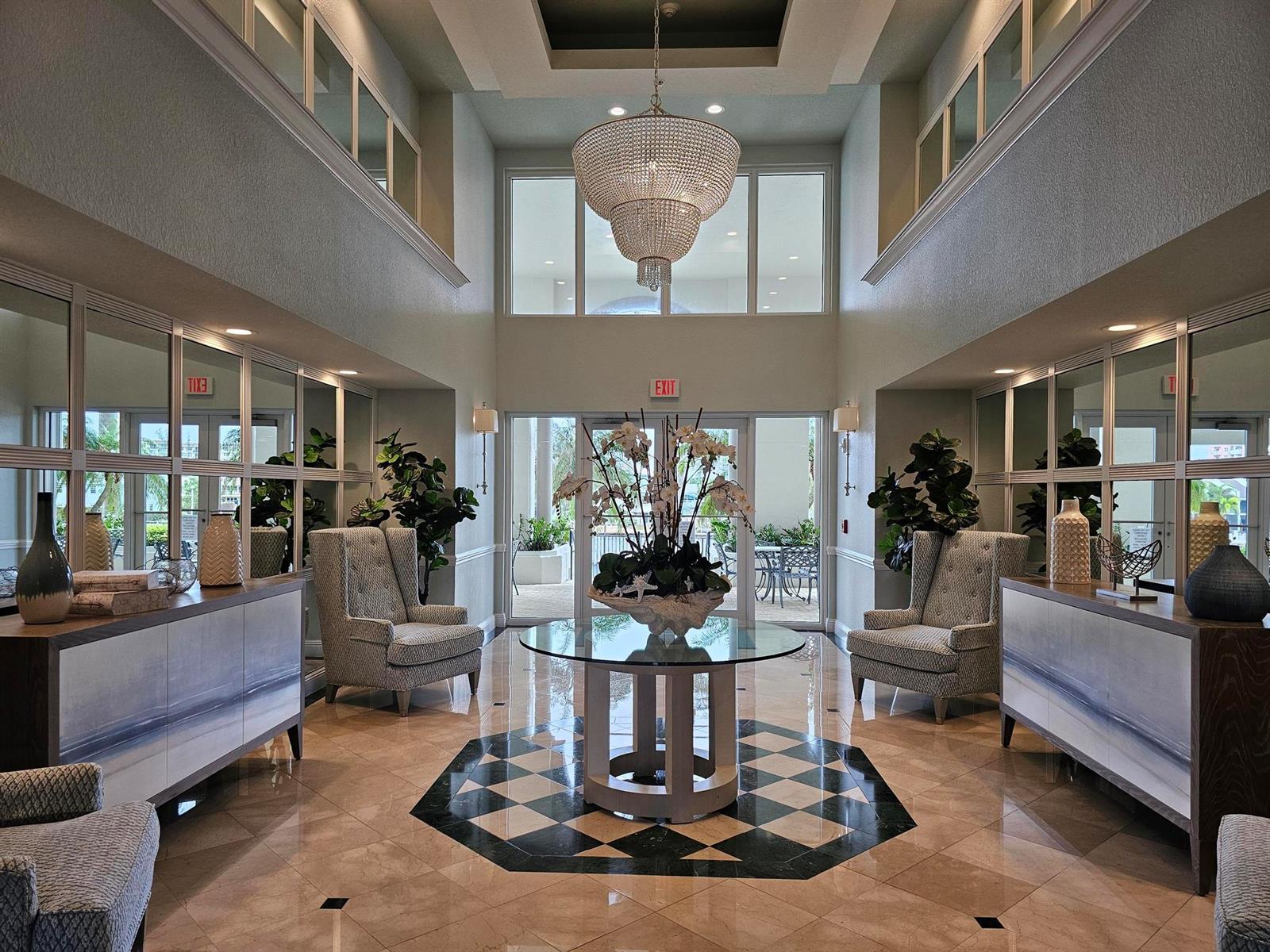 A symmetrical lobby features a crystal chandelier, checkered floor inlay, and two wingback chairs — 2880 NE 14th St Causeway # 904, Pompano Beach FL 33062, POMPANO BEACH, FL