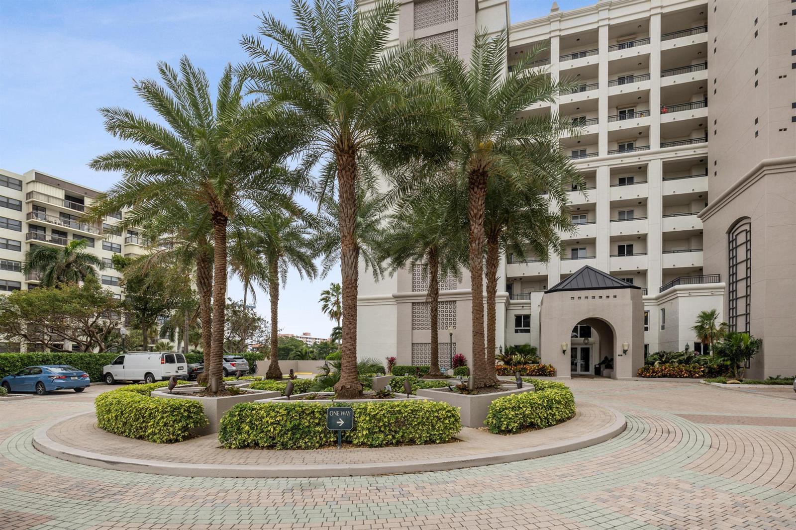 A circular driveway with palm trees and landscaping leads to the entrance of a tall building — 2880 NE 14th St Causeway # 904, Pompano Beach FL 33062, POMPANO BEACH, FL