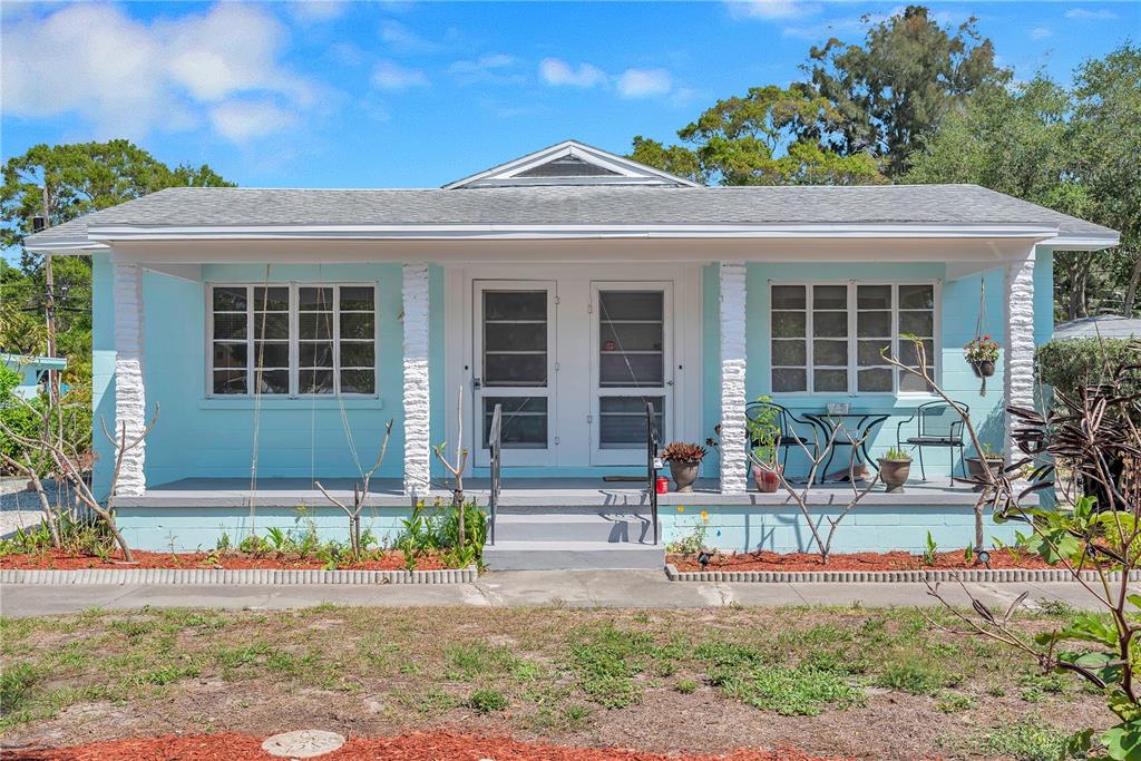A light blue single-story house with a front porch and two white entry doors — 5027 28TH AVENUE S, GULFPORT, FL