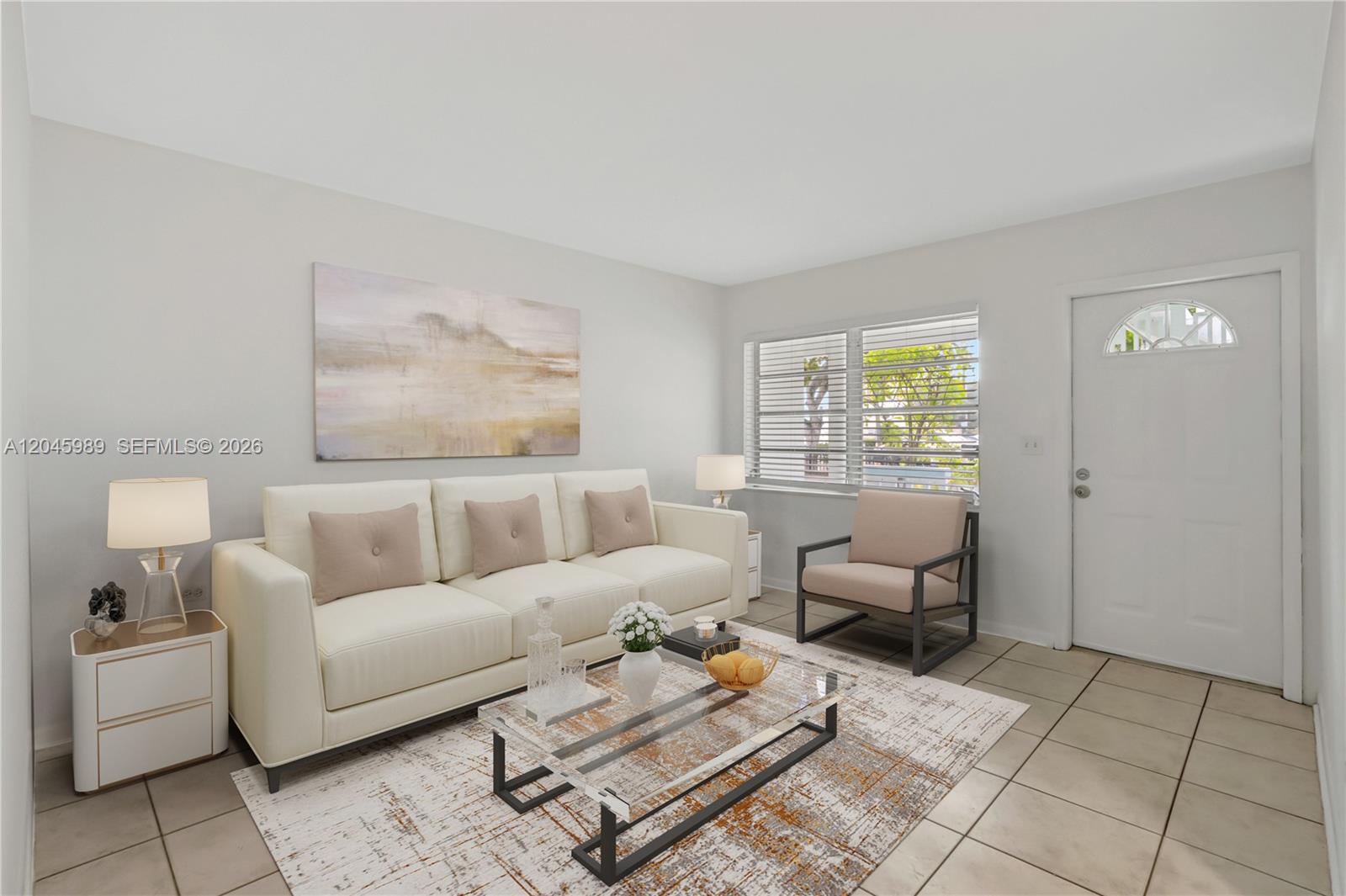 A living room features a white sofa, a glass coffee table, and tile flooring — 202 N K St # 7, Lake Worth FL 33460, LAKE WORTH, FL