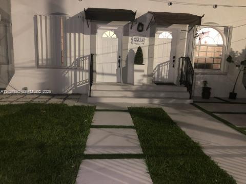 A white duplex exterior features two front doors with black awnings and a paved walkway — 3244 SW 3rd St # L, Miami FL 33135, MIAMI, FL