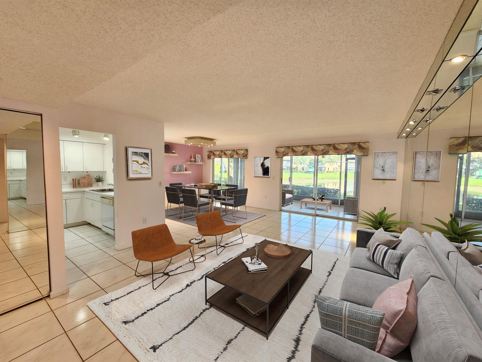 An open-concept living and dining area features tile floors, a gray sofa, and patio access — 9963 Seacrest Circle # 101, Boynton Beach FL 33437, BOYNTON BEACH, FL